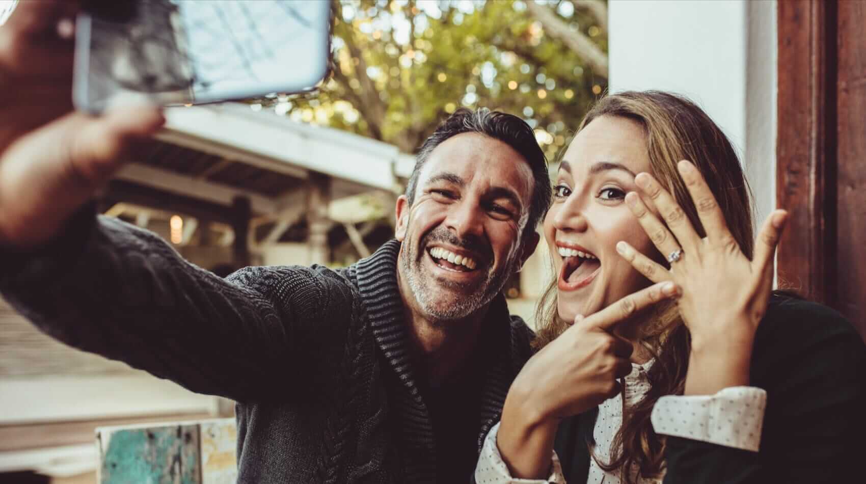 Selfie of couple announcing engagement Mile High Psychology Example of when to seek premarital counseling