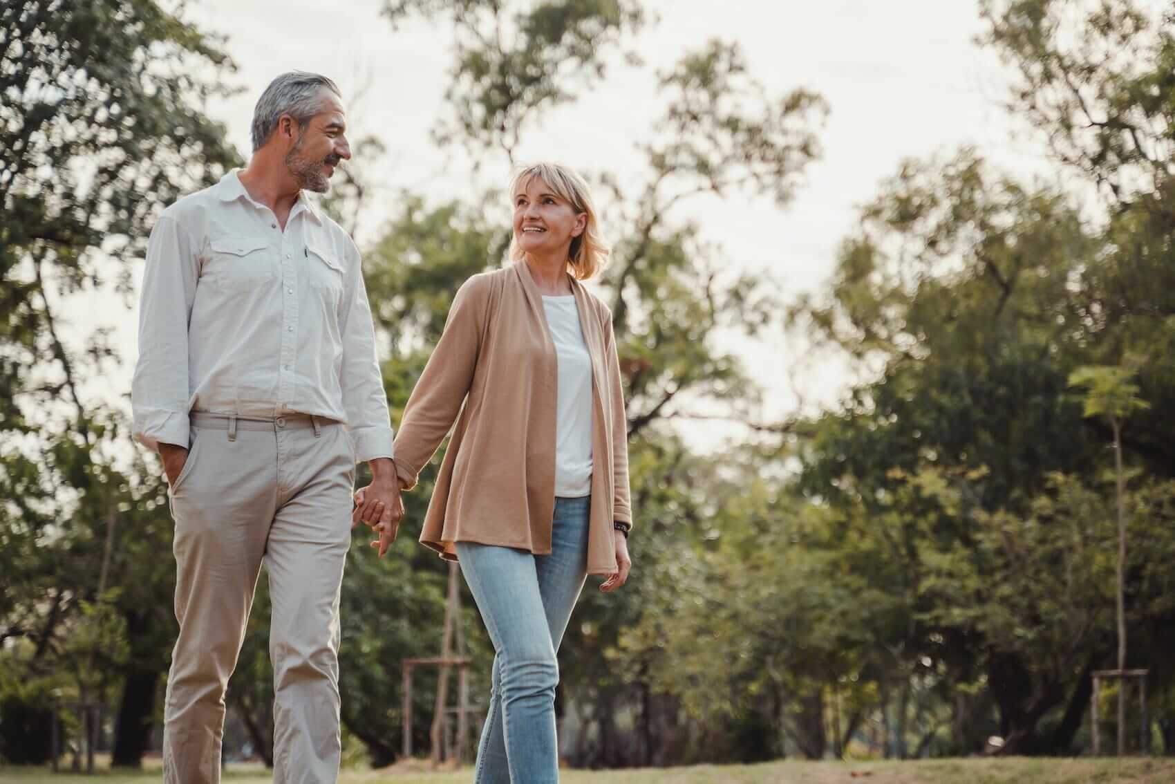 Married couple walking and talking Mile High Psychology Example of renewed connection through marriage counseling