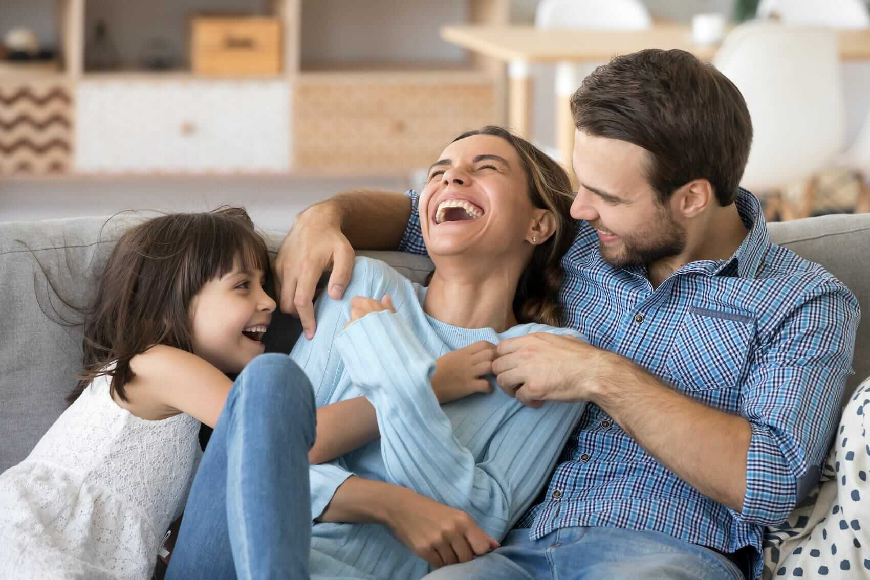 Married couple on couch with daughter Mile High Psychology Example of rekindled connection through marriage counseling