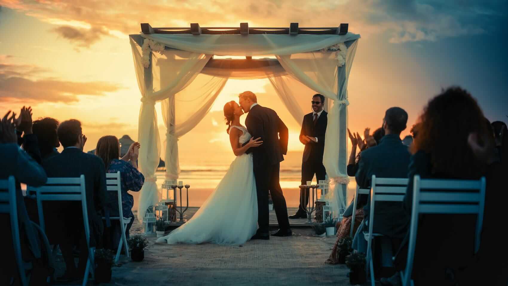 Wedding kiss at wedding ceremony at sunset Mile High Psychology Example of culmination of engagement - the wedding day