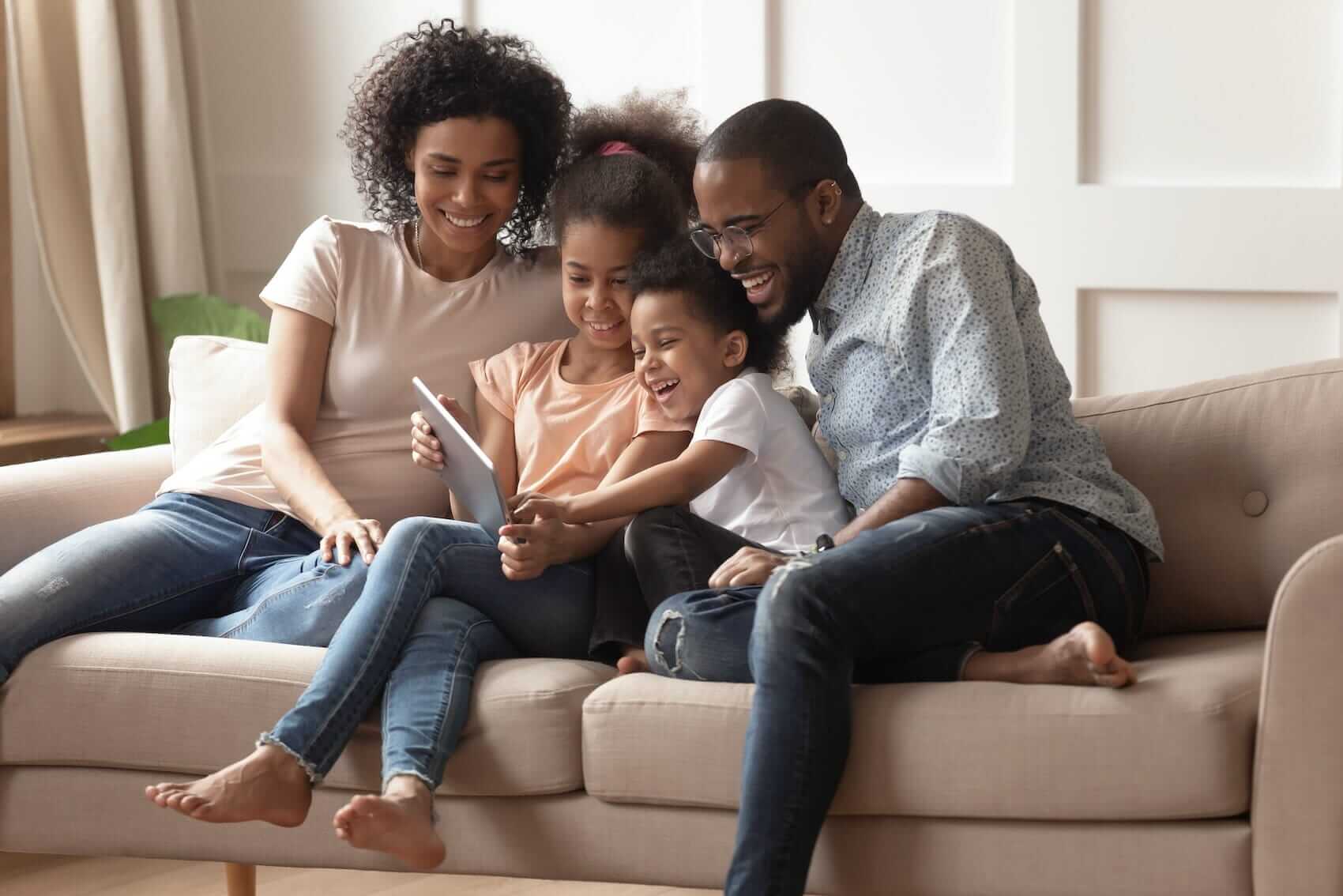 Family on sofa together Mile High Psychology Example of reinvigorated connection cultivated through couples therapy