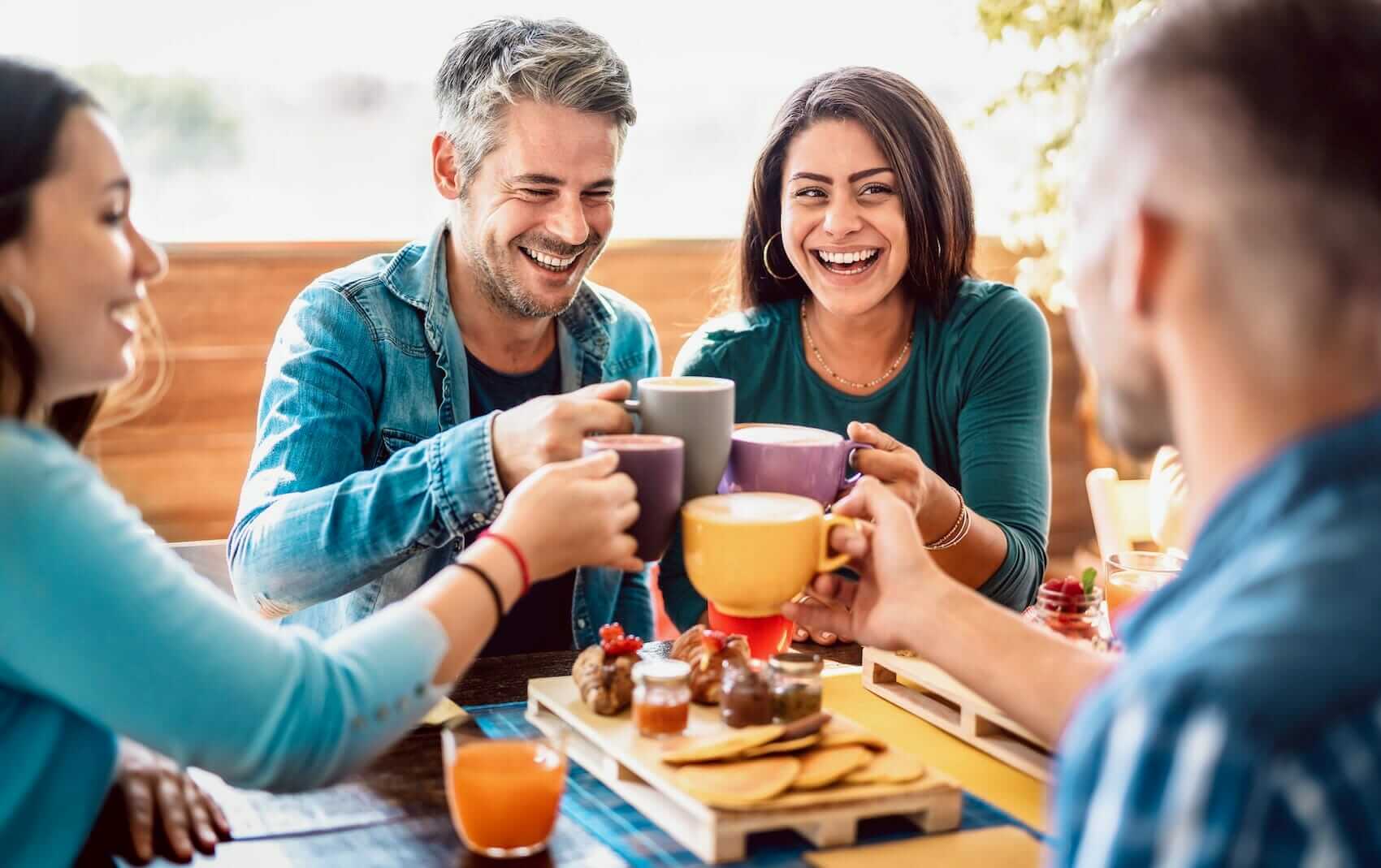 Friends having fun together at coffee shop Mile High Psychology Example the joy of friendship
