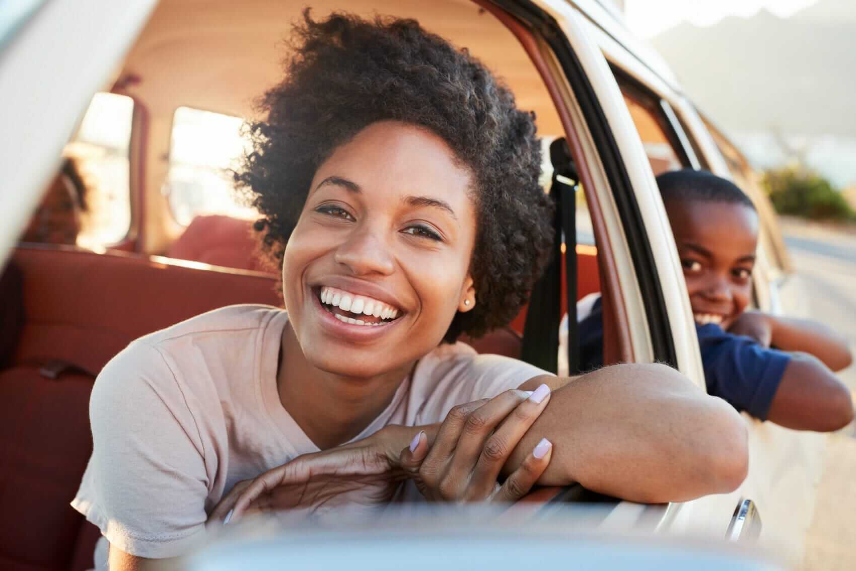 Mother and son on roadtrip Mile High Psychology Mother and son on road trip with heads peering through open windows in their parked car